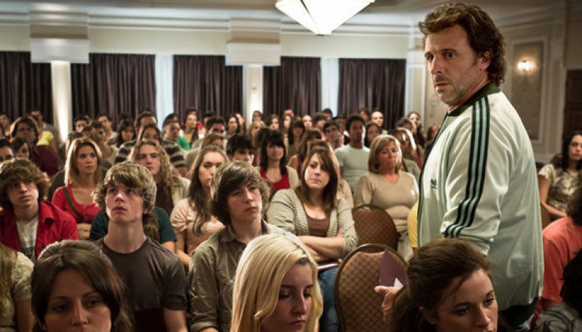 David stands in front of a room full of seated teenagers