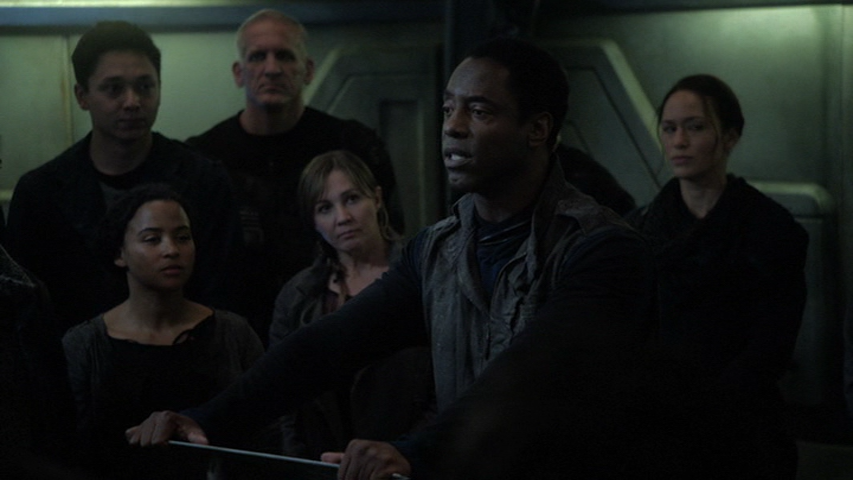 Thelonius (Isaiah Washington) speaks to a group aboard a space station