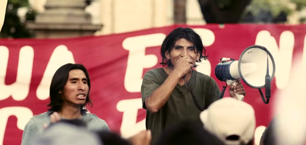 Daniel (Juan Carlos Aduviri) speaks into a megaphone at a protest