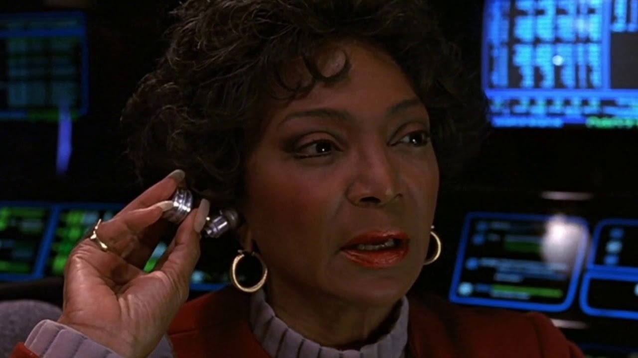 Uhura (Nichelle Nichols) listens to her earpiece in Star Trek: The Undiscovered Country