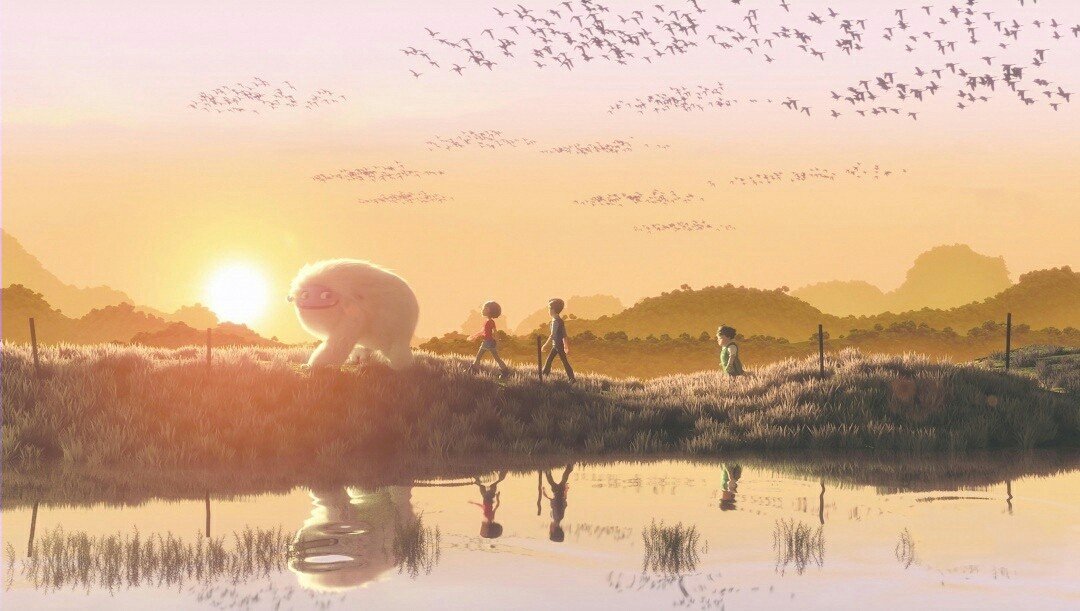 The Yeti, Yi, Jin, and Peng walk through a field at sunset. They are reflected in a nearby river, and birds fly above them.