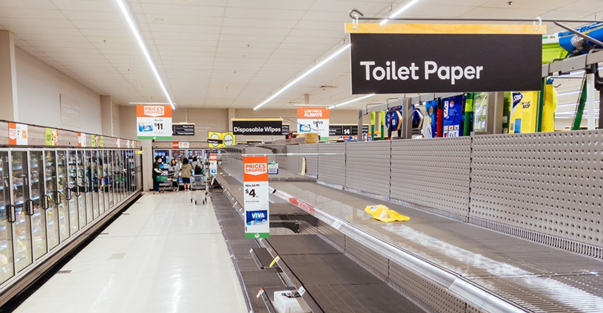 An empty shelf in the toilet paper aisle of a store