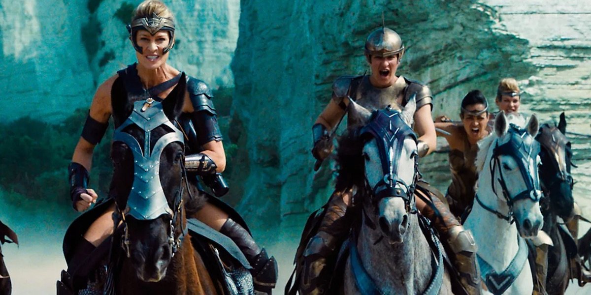 Antiope (Robin Wright) leads a groups of women warriors on horseback.