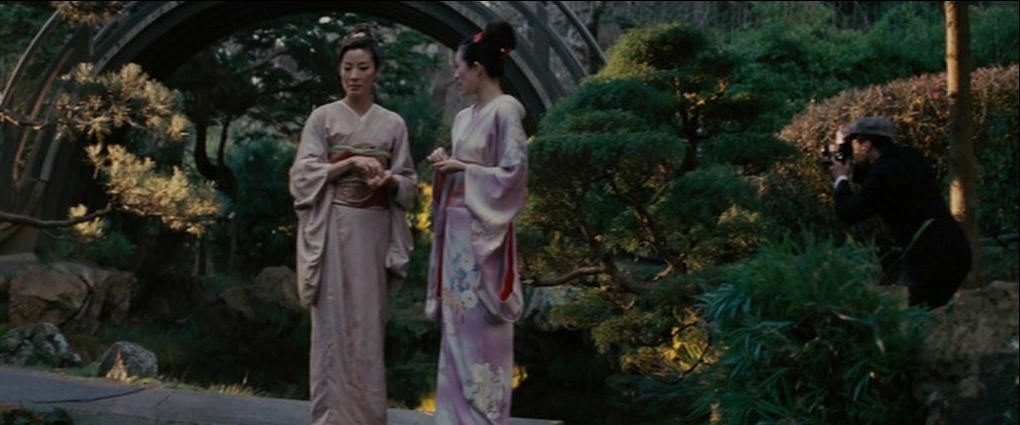 A pair of geisha converse in a garden