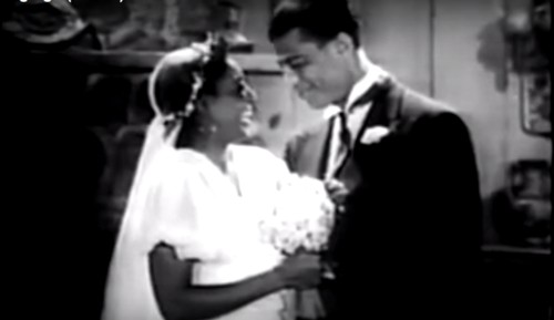 A still from Son of Ingagi. A young Black couple, Eleanor and Bob Lindsay (Daisy Bufford and Alfred Grant) exchange wedding rings.