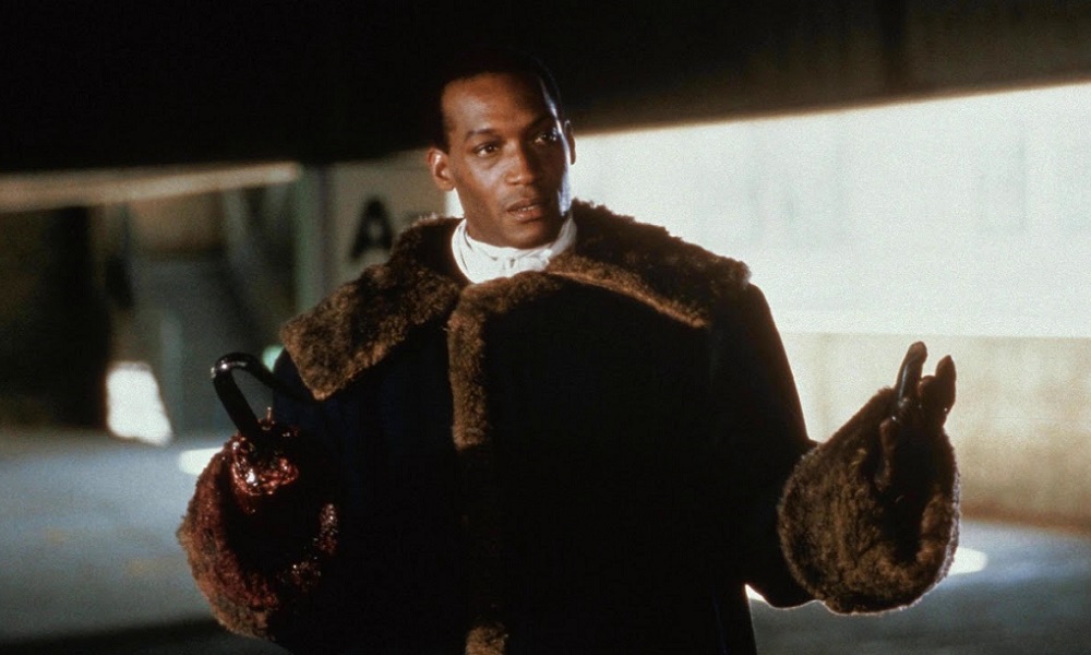 Tony Todd as Candyman. He's a young Black man with a hook in place of a right hand. He wears a brown fur coat.