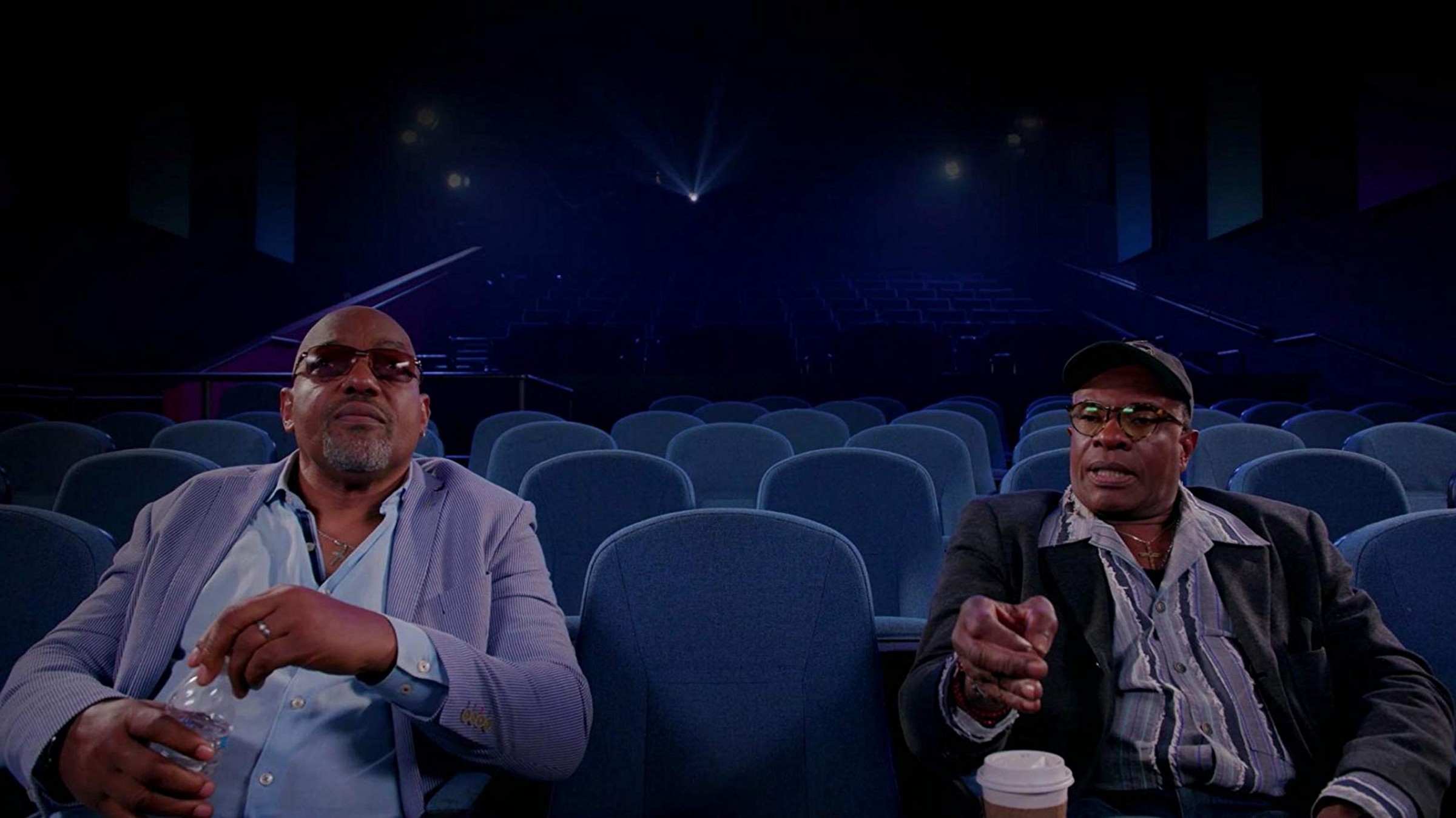 Keith David and Ken Foree (both Black men and prominent actors from horror films) sit in a movie theatre