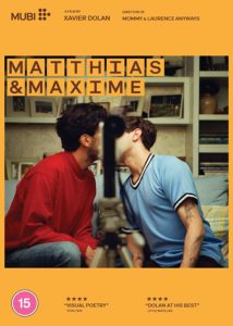 Poster for Matthias & Maxime. The pair kiss with a camera blocking their face.