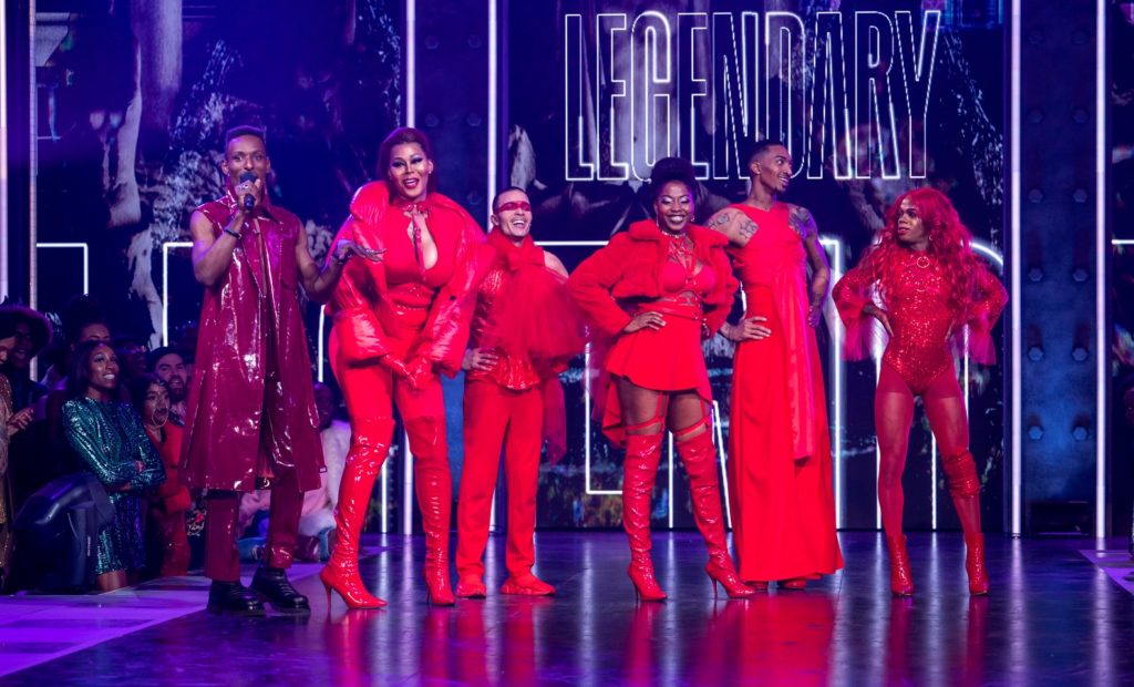 Host Dashuan Wesley presents the members of the House of Lanvain. All wear elaborate red outfits.