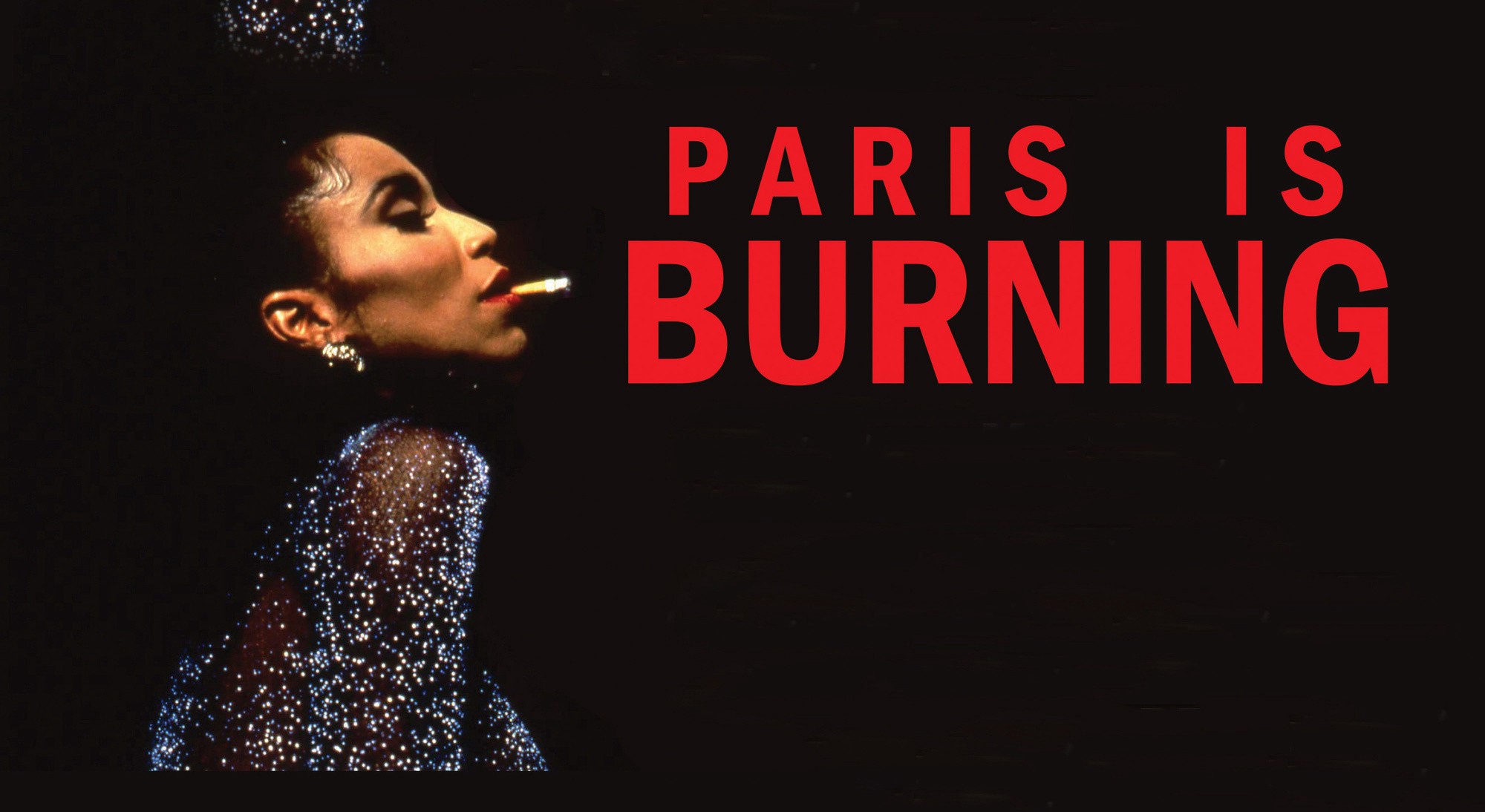 Octavia St. Laurent, ballroom performer and activist, poses against a black background. She smokes a cigarette and wears a shimmering blue gown. To her right, red text reads "PARIS IS BURNING"