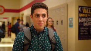 Ben standing in front of lockers at school