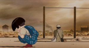 Setsuko and Seita stand outside, with Seita's back showing. Setsuko looks down sadly.