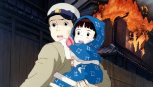 Seita holding Setsuko during an air raid. 