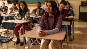 Devi watching Aneesa in a classroom as Aneesa smiles