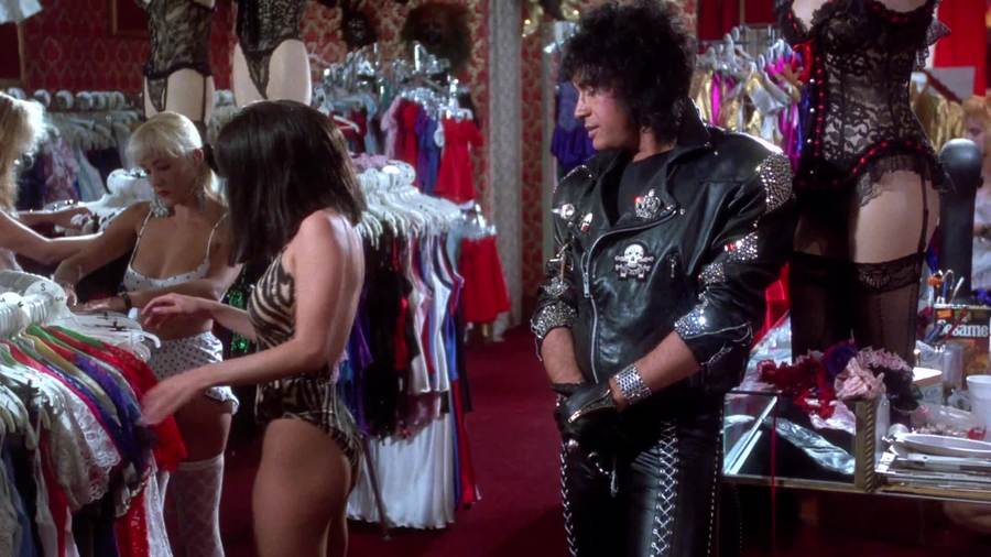 Gene Simmons at a lingerie store looking at a woman in lingerie