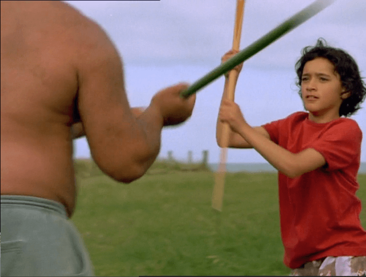 Pai is outside, training with her uncle with fighting sticks