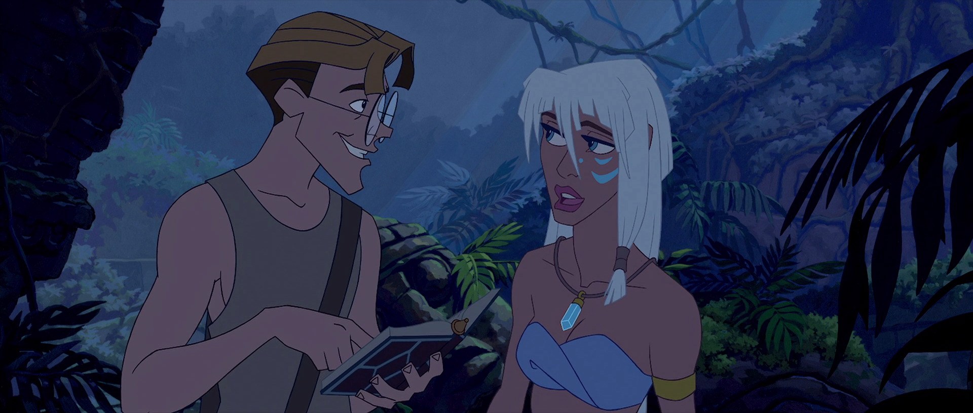 Milo and Kida stand in a jungle, smiling at each other. Milo holds a book.