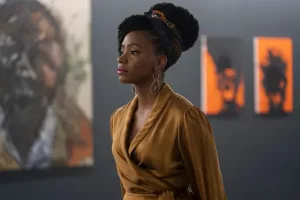 A still from 'Candyman' of Brianna standing in her art gallery