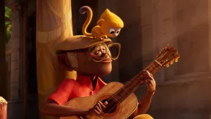 A still from 'Vivo' of Vivo the monkey on Andres's shoulder as he plays guitar
