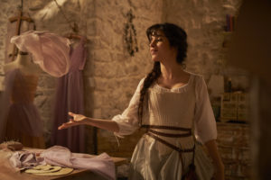 A still from 'Cinderella' (2021) of Camila Cabello as Cinderella dancing and singing to herself