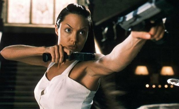 lara in a white dress, holding two guns