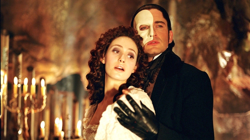 the phantom embracing chrisitine, behind candles