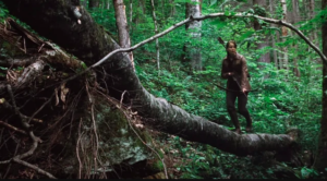 Still of Katniss Everdeen with bow and arrow in forrest from The Hunger Games