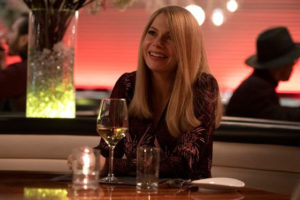 A still from "Venom: Let There Be Carnage" of Anne smiling in a restaurant