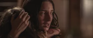A still from the Netflix film "Fever Dream" of a woman crying and holding her child