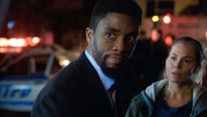 Chadwick Boseman as Andre Davis looks over his shoulder.