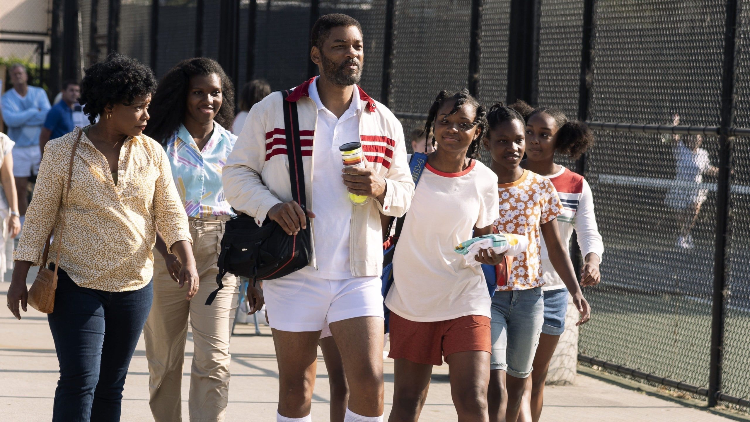 A still from 'King Richard' of Richard and his family walking through the tennis courts