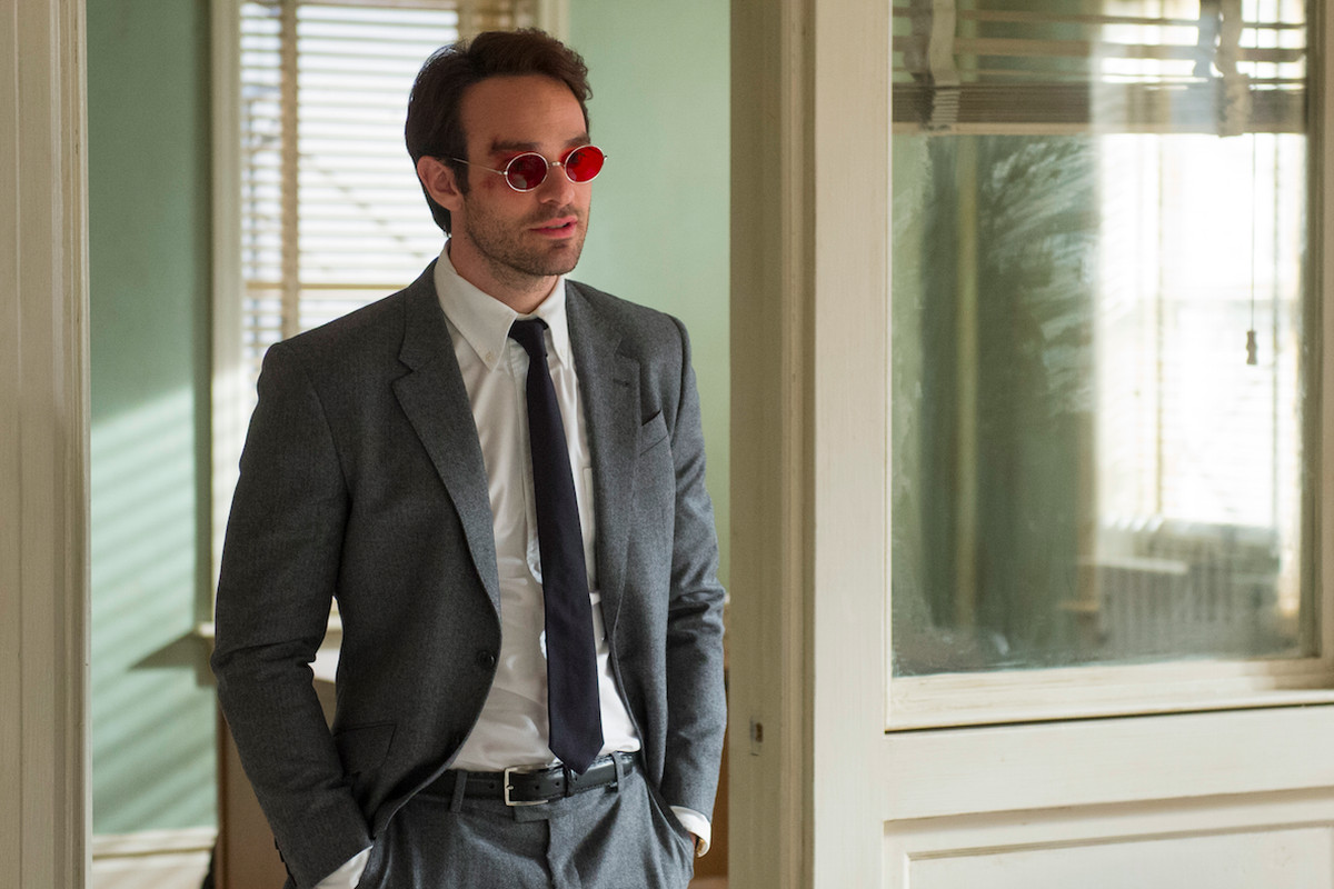 A still from Daredevil of Matt Murdock dressed in a suit standing with his hands in his pockets