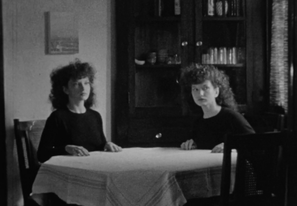 two women (played by Maya deren) sitting at the table