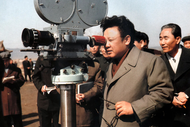 Kim Jong-il and crew behind a movie camera.