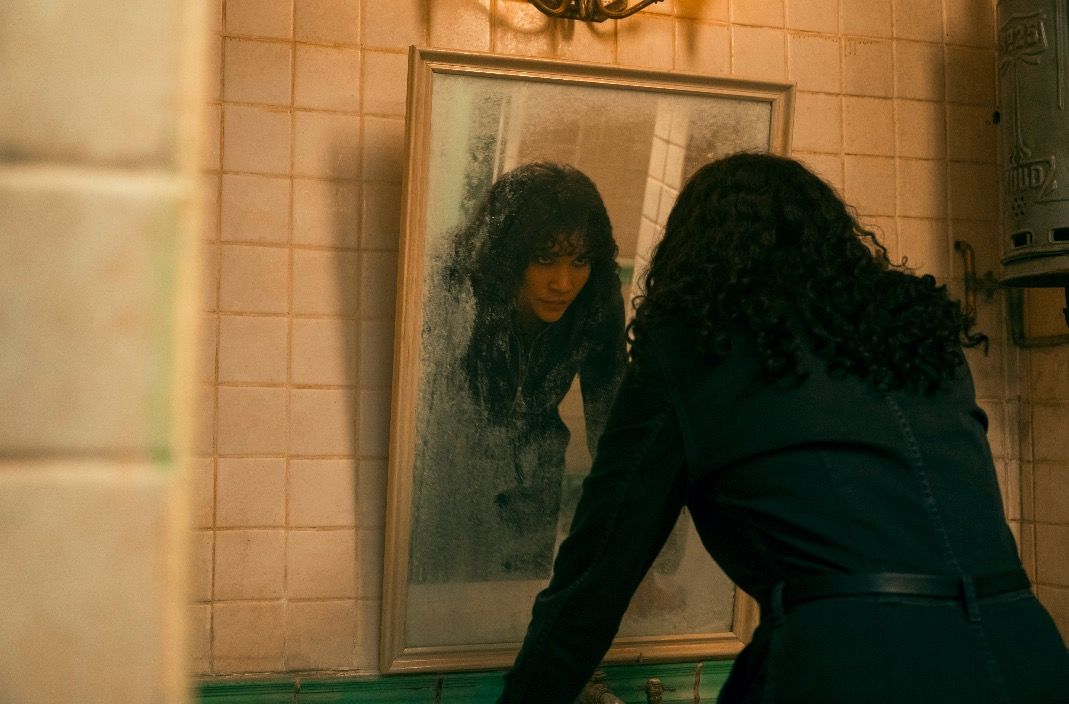 A still from Umbrella Academy season 3 of Allison angrily looking at herself in a mirror