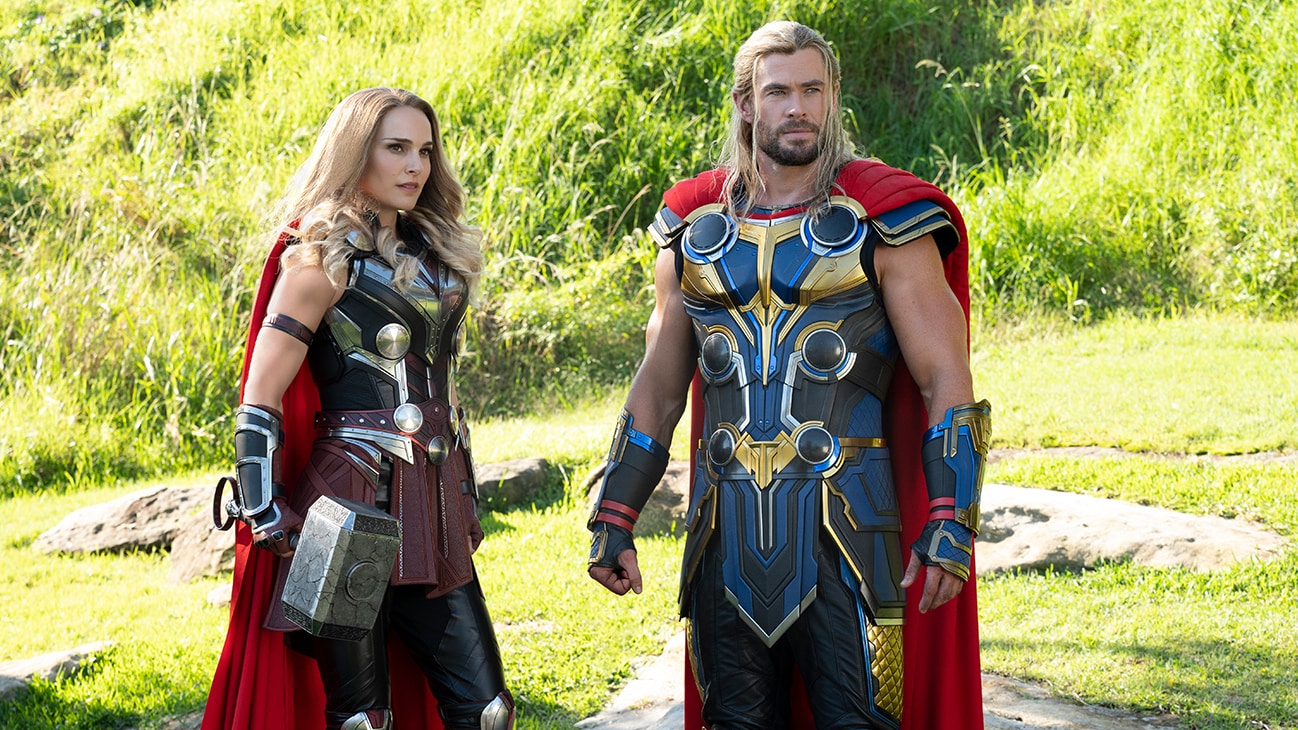 A still from Thor: Love and Thunder of the two Thors standing next to each other in a green field