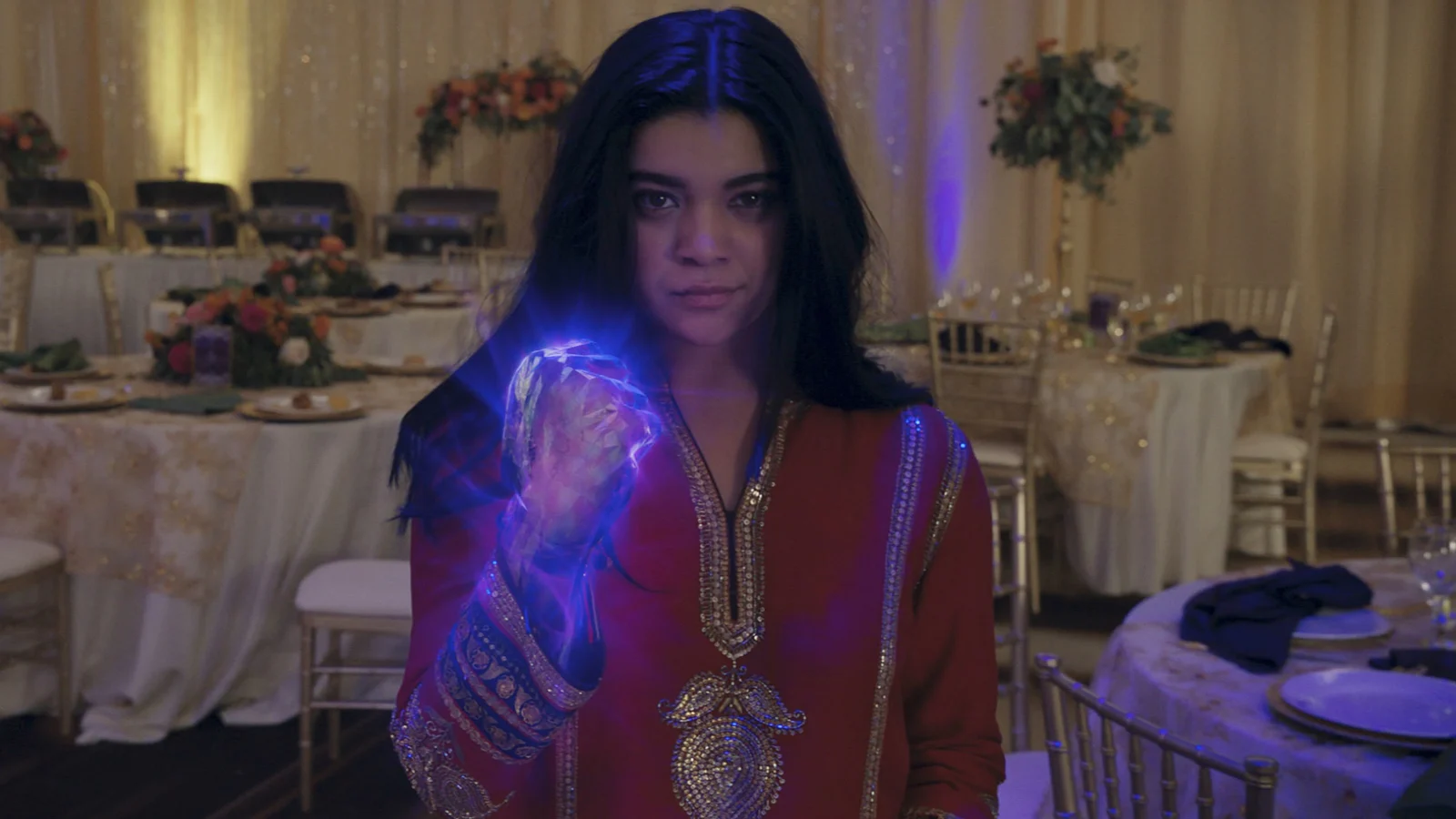 Kamala smirks with her glowing purple fist