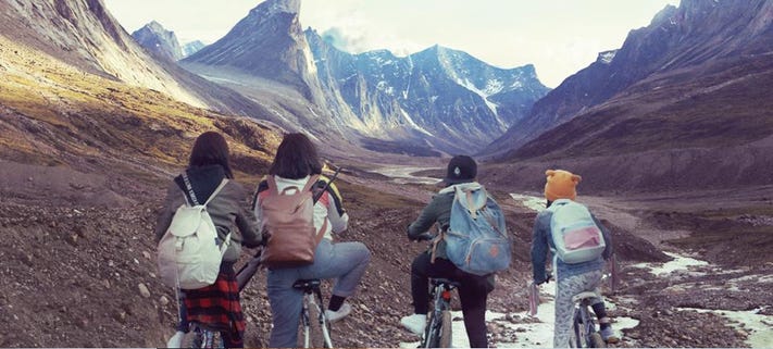 Jesse, Maika, Aju, and Lee Lee riding their bikes