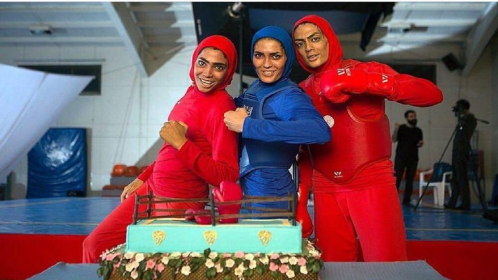 Three Iranian Sisters pose in their martial arts gear.