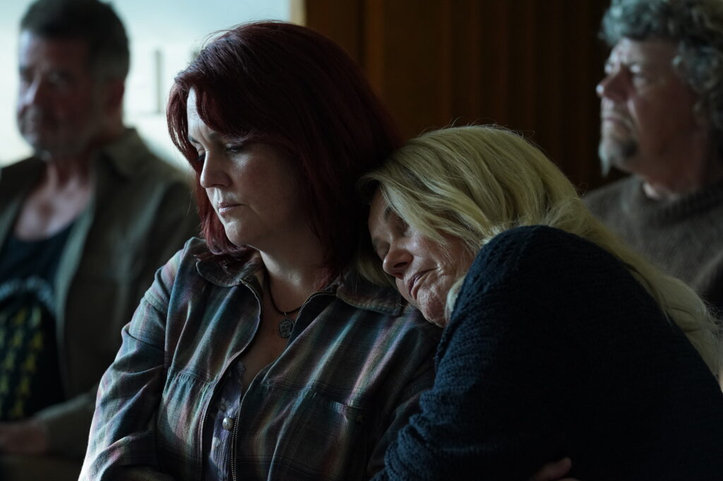 Sonya leans on Anna's shoulder