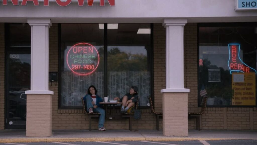 Caity and her best friend eat outside of the Chinese restaurant