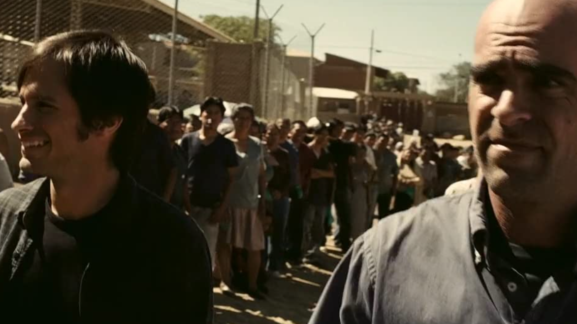 Sebastián (Gael Garciá Bernal) and Costa (Luis Tosar) survey a line of Indigenous actors