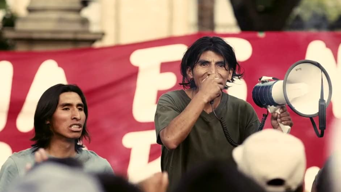 Daniel (Juan Carlos Aduviri) speaks into a megaphone at a protest